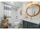 Stylish bathroom featuring black and white patterned tile floors and gold fixtures, vanity, mirror, and shower at 10043 Tepa Pl, Tega Cay, SC 29708