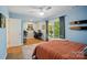Cozy bedroom featuring hardwood floors, a ceiling fan, and natural light from the window at 10043 Tepa Pl, Tega Cay, SC 29708