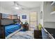 Well-lit bedroom featuring bunk beds, ceiling fan, and window views at 10043 Tepa Pl, Tega Cay, SC 29708