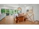 Bright dining area featuring a wood table, benches, and sliding glass doors to an outdoor living space at 10043 Tepa Pl, Tega Cay, SC 29708