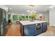 Open-concept kitchen with a sizable island, built-in microwave, and views of the living room and outdoor scenery at 10043 Tepa Pl, Tega Cay, SC 29708