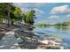 Scenic waterfront access with stairs, a gazebo, walkway, and views of the serene lake at 10043 Tepa Pl, Tega Cay, SC 29708