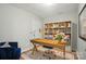 Inviting home office featuring a rustic desk, a plush chair and a large bookshelf with natural light at 10043 Tepa Pl, Tega Cay, SC 29708