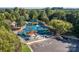 Overhead view of a colorful neighborhood playground, featuring multiple slides, swings, and a secure fenced perimeter at 10043 Tepa Pl, Tega Cay, SC 29708