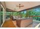 Inviting covered porch featuring ceiling fans and comfortable wicker seating overlooking the surrounding greenery at 10043 Tepa Pl, Tega Cay, SC 29708