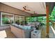 Inviting covered porch featuring ceiling fans and comfortable wicker seating with views through sliding glass doors at 10043 Tepa Pl, Tega Cay, SC 29708