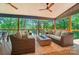 Covered porch with comfortable seating and view of the tree-filled landscape at 10043 Tepa Pl, Tega Cay, SC 29708