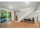 Bright room with hardwood floors that walks out onto a covered patio overlooking a green landscape at 10043 Tepa Pl, Tega Cay, SC 29708