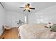Bright bedroom featuring hardwood floors, ceiling fan, and a desk area bathed in natural light at 1008 Valley St, Kannapolis, NC 28081