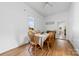 Bright dining room boasts wood floors, a large table setting, and natural light at 1008 Valley St, Kannapolis, NC 28081