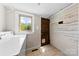Tile floor laundry room with window and adjacent access door at 1008 Valley St, Kannapolis, NC 28081