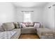 Bright living room with hardwood floors, large sectional sofa, and a window view at 1008 Valley St, Kannapolis, NC 28081