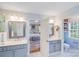 Spacious bathroom with dual vanities, shower, toilet, and a glimpse into the adjacent bedroom at 10127 Tallent Ln, Huntersville, NC 28078