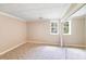 Neutral bedroom with carpet, window view, and closet with mirrored doors at 10127 Tallent Ln, Huntersville, NC 28078