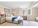 A beautifully furnished bedroom with a bed, two side tables, wall art and natural light at 10127 Tallent Ln, Huntersville, NC 28078
