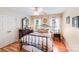 Cozy bedroom featuring wood floors, iron bed frame, and decorative floral pillows at 10127 Tallent Ln, Huntersville, NC 28078