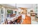 Open dining area featuring hardwood floors, chandelier, and access to a screened porch at 10127 Tallent Ln, Huntersville, NC 28078