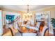 Elegant dining room featuring hardwood floors, chandelier lighting, and a seamless flow to the living spaces at 10127 Tallent Ln, Huntersville, NC 28078