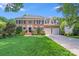 Beautiful brick two-story home with manicured lawn and mature trees at 10127 Tallent Ln, Huntersville, NC 28078