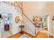Bright foyer with staircase, hardwood floors, and view into dining room at 10127 Tallent Ln, Huntersville, NC 28078
