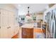 Bright kitchen featuring stainless steel appliances, granite counters, pendant lighting, and a view of the dining area at 10127 Tallent Ln, Huntersville, NC 28078