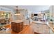 Open kitchen boasts wood floors, granite countertops, pendant lighting, and flows seamlessly into the living spaces at 10127 Tallent Ln, Huntersville, NC 28078