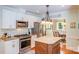 Well-lit kitchen with stainless steel appliances, granite countertops, and a view to the adjacent dining area at 10127 Tallent Ln, Huntersville, NC 28078