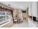 Charming kitchenette area features window seat and white countertops and cabinets at 10127 Tallent Ln, Huntersville, NC 28078