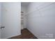 Walk-in closet with built in shelves and laminate wood floors at 10410 Bradstreet Commons Way, Charlotte, NC 28215