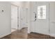 A welcoming entryway featuring decorative trim and wood-look flooring at 10410 Bradstreet Commons Way, Charlotte, NC 28215