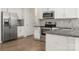 A modern kitchen featuring stainless steel appliances, granite countertops, and ample storage at 10410 Bradstreet Commons Way, Charlotte, NC 28215