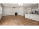 Open floor plan of living room showing fireplace and kitchen at 10410 Bradstreet Commons Way, Charlotte, NC 28215