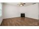 Living room featuring a fireplace, ceiling fan, and laminate floors at 10410 Bradstreet Commons Way, Charlotte, NC 28215