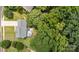 Aerial view of a house with a deck, hot tub, mature trees and a landscaped yard at 108 Shade Tree Cir, Fort Mill, SC 29715