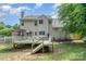 Exterior view of the home featuring an outdoor deck perfect for entertainment, overlooking a lush backyard at 108 Shade Tree Cir, Fort Mill, SC 29715