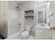 Bright bathroom featuring a shower-tub combo, wooden shelves, and a vanity with sink and storage at 108 Shade Tree Cir, Fort Mill, SC 29715