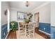 Formal dining area with elegant wainscoting, hardwood floors, stylish chandelier, and sailboat art at 108 Shade Tree Cir, Fort Mill, SC 29715
