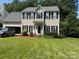 Traditional two-story home featuring a well-manicured lawn and an attached two car garage at 108 Shade Tree Cir, Fort Mill, SC 29715