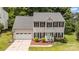 Charming two-story home features a well-maintained lawn, attached garage, and a welcoming front entrance with bright blue door at 108 Shade Tree Cir, Fort Mill, SC 29715