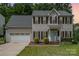 Charming two-story home with gray siding, black shutters, and an attached two-car garage at 108 Shade Tree Cir, Fort Mill, SC 29715