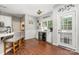 Stylish bar area featuring hardwood floors, seating, modern drink cooler, and natural light at 108 Shade Tree Cir, Fort Mill, SC 29715