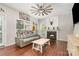 Inviting living room with a fireplace, hardwood floors, guitar, and a view to the backyard at 108 Shade Tree Cir, Fort Mill, SC 29715
