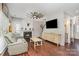 Cozy living room featuring a fireplace, ceiling fan, hardwood floors, and a comfortable couch at 108 Shade Tree Cir, Fort Mill, SC 29715
