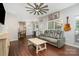 Comfortable living room with hardwood floors, guitar decor, ceiling fan, and mini bar at 108 Shade Tree Cir, Fort Mill, SC 29715