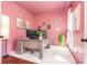 Bright pink home office with desk, decorations, and ample natural light from the windows at 108 Shade Tree Cir, Fort Mill, SC 29715