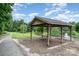 Community pavilion with picnic tables, perfect for outdoor gatherings, overlooking a scenic pond at 108 Shade Tree Cir, Fort Mill, SC 29715