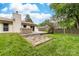 Backyard with well-maintained lawn, patio, and a relaxing hot tub, ideal for outdoor entertainment at 10951 Fox Mill Ln, Charlotte, NC 28277