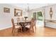 Charming dining room with hardwood floors, a stylish chandelier, and sliding glass doors at 10951 Fox Mill Ln, Charlotte, NC 28277
