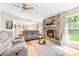 Bright living room with a stone fireplace, large windows, and comfortable seating at 10951 Fox Mill Ln, Charlotte, NC 28277