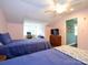 Bright bedroom features twin beds, a ceiling fan, and a workspace with a desk, chair and computer at 11120 Sevilla Ct, Charlotte, NC 28226